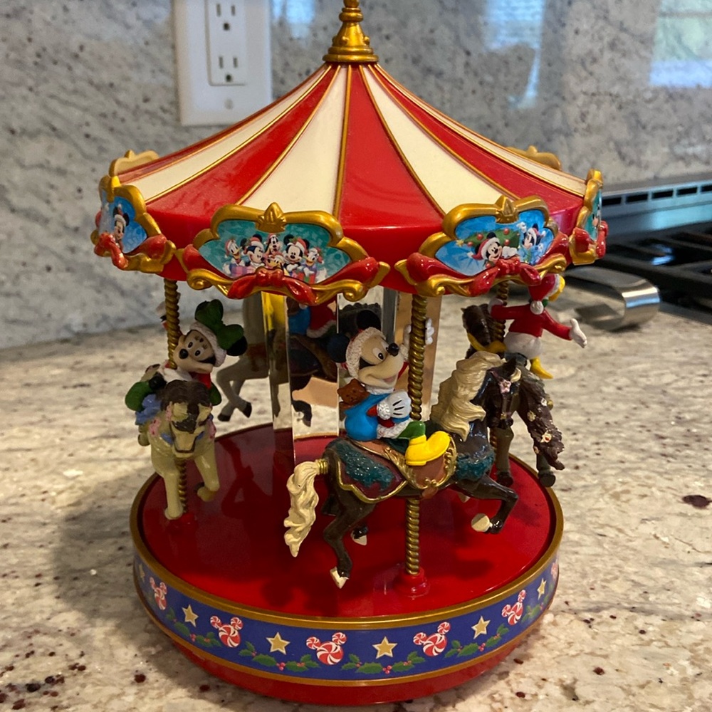 Christmas Carousel with Disney characters rising the horses. Plays music